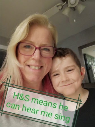 Partner in Care with son showing what hearing and speech means to them